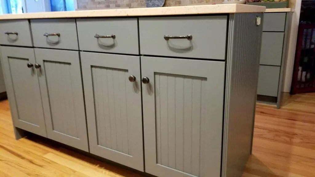 Close-up of modern gray cabinets with new hardware highlighting cabinet painting for a refreshed kitchen look.