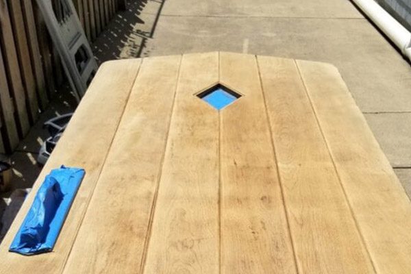 A wooden table with blue squares on it.
