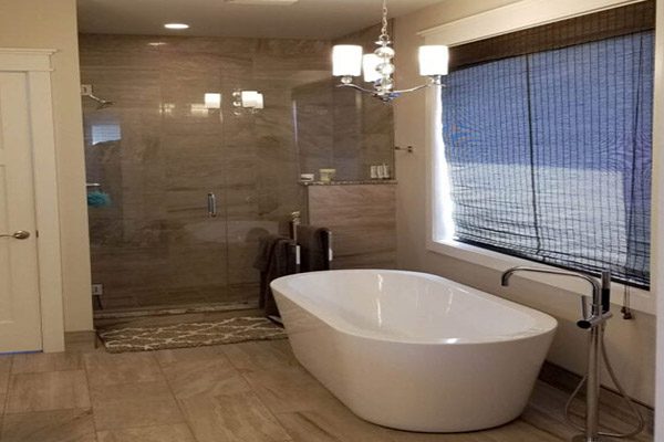 A bathroom with a large window and a tub.