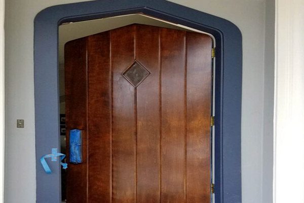 A door with a wooden frame and blue trim.