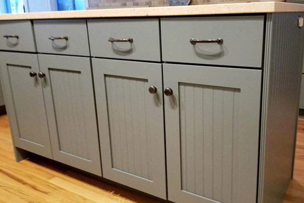 A close up of the cabinet doors and drawers.