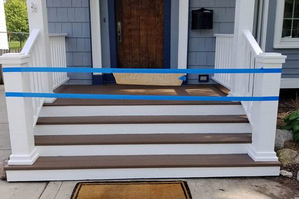 A blue and white striped stair railing on steps.