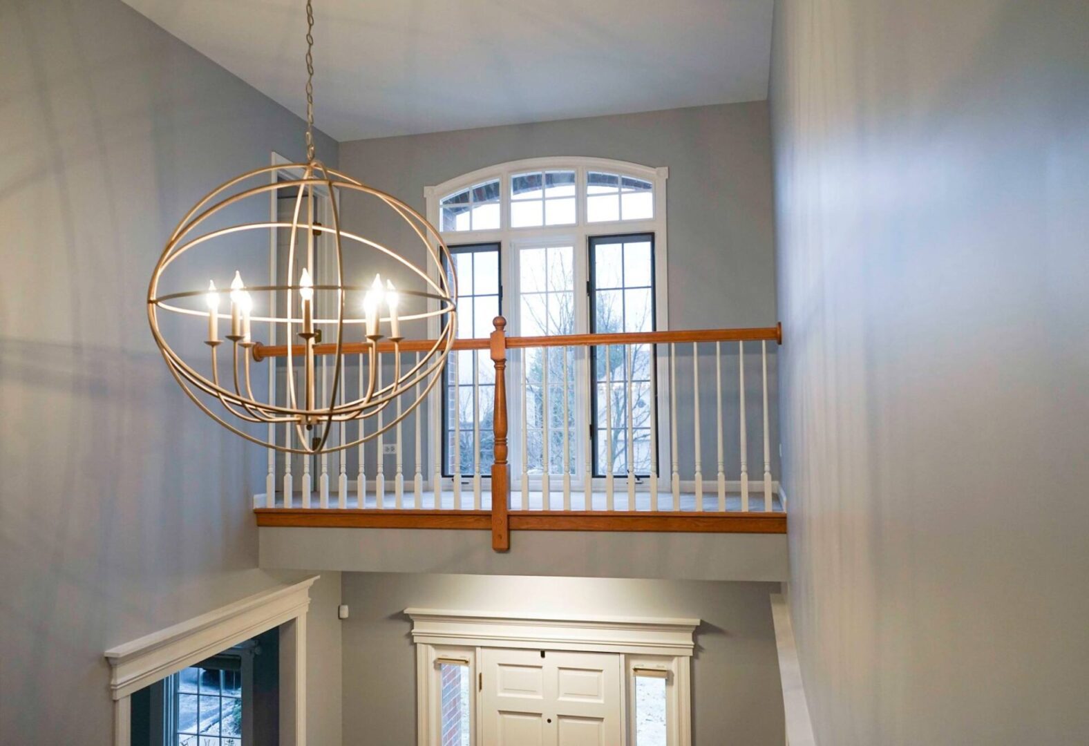 A large foyer with two floors and a chandelier.