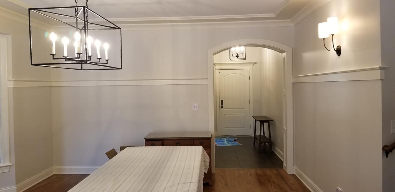 A bedroom with a bed and a door way