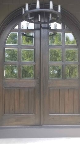 A pair of wooden doors with glass panes.