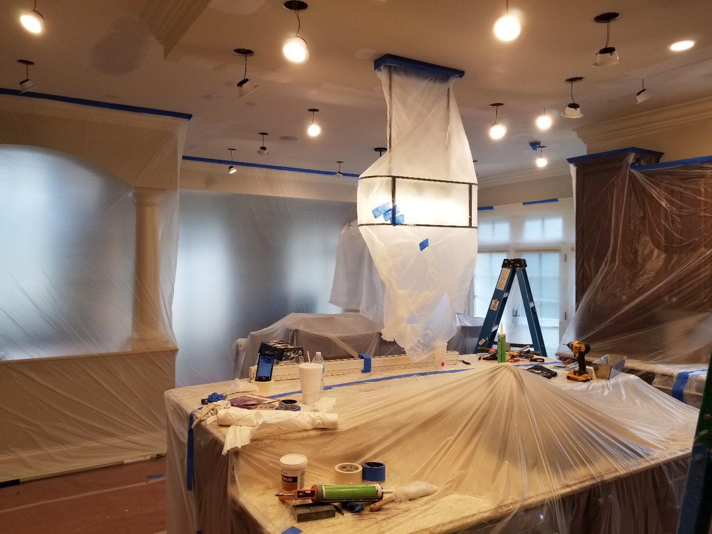A room being remodeled with paint and construction supplies.