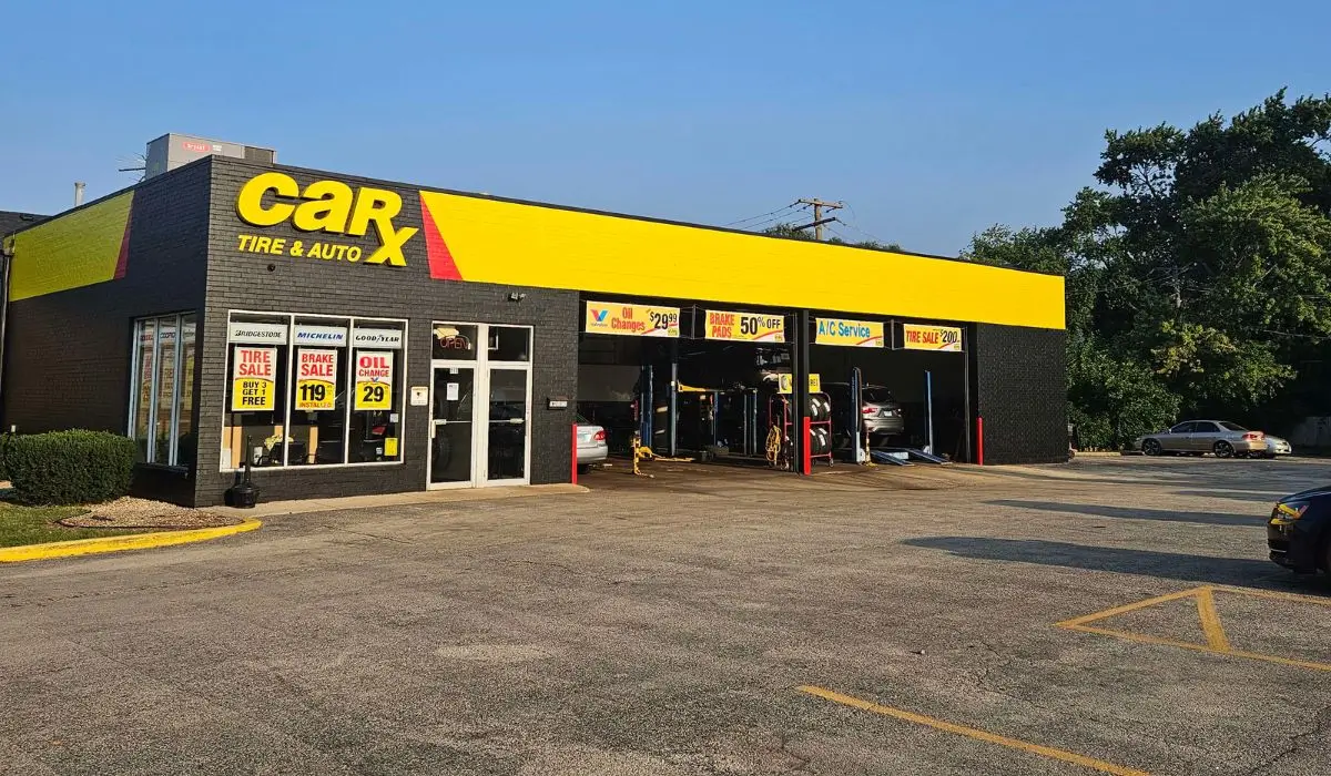 Exterior view of auto shop featuring bold branding, showcasing professional paint solutions for commercial curb appeal.